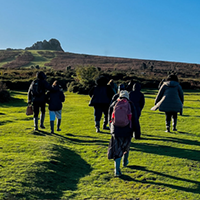Group of people walking up the hill towards Haytor