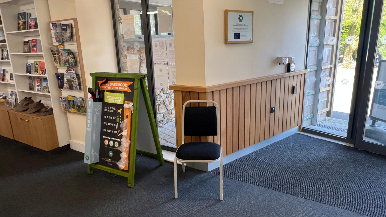 Chair against a wall next to a litter pick board