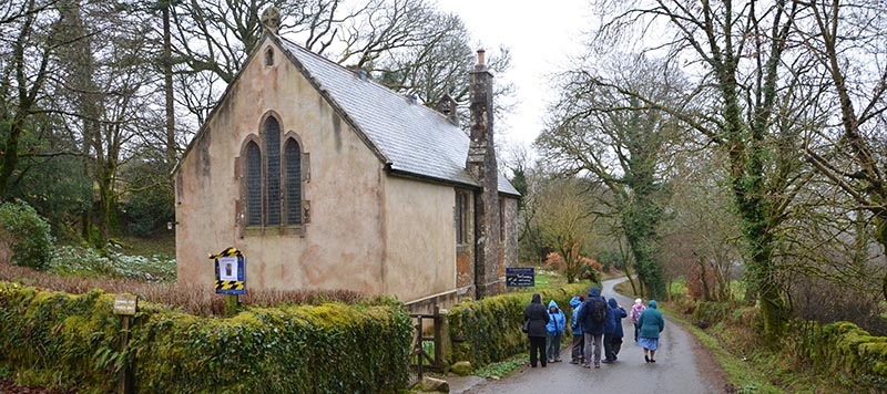 Group of people walking past St Raphael Church