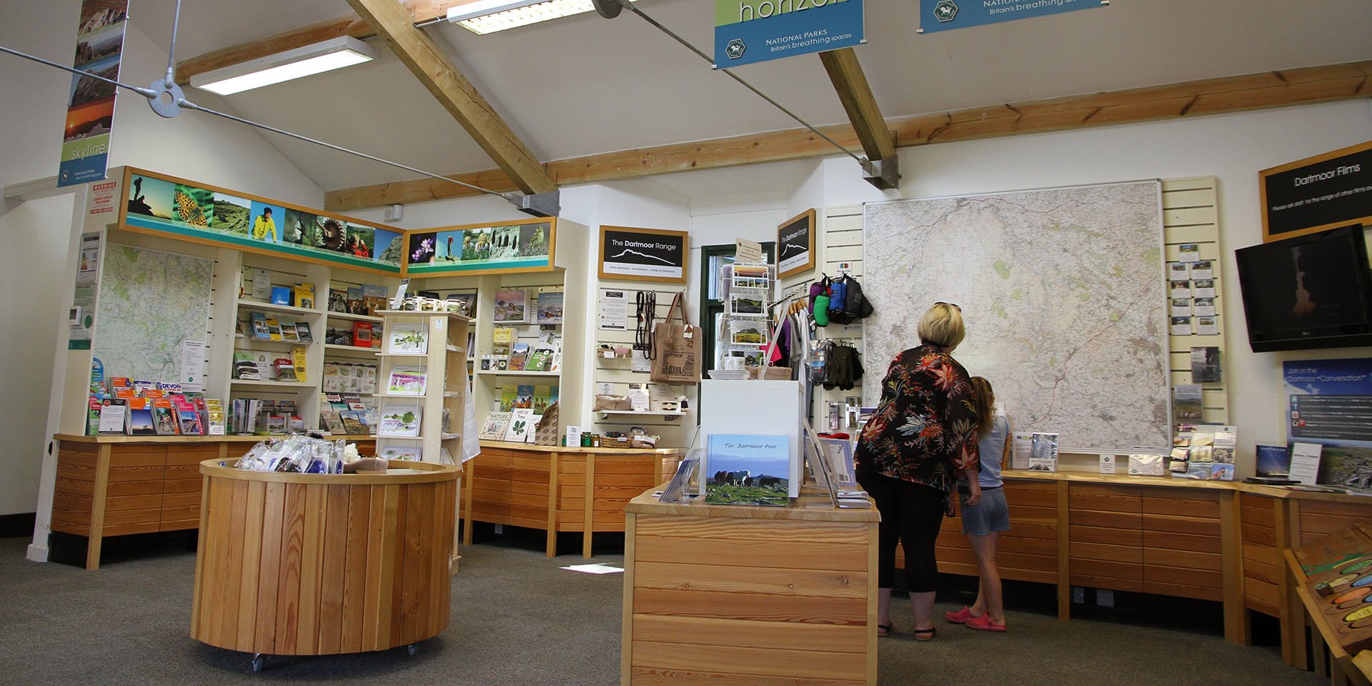 Visitors looking at Haytor Visitor Centre display