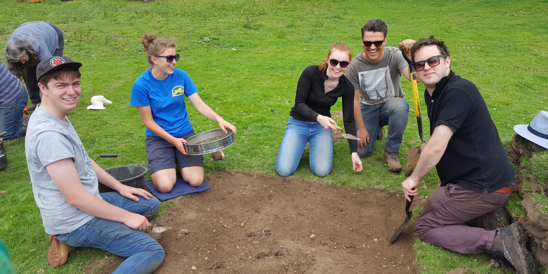 Students digging a test pit