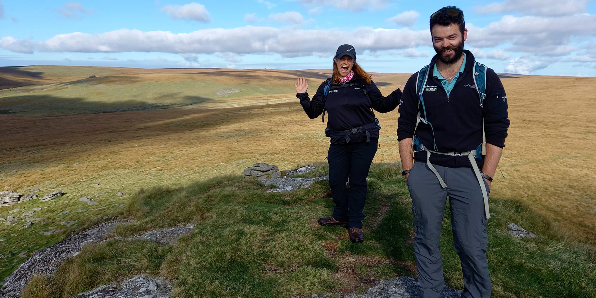 Two Rangers standing on the moors with a vast expanse behind them