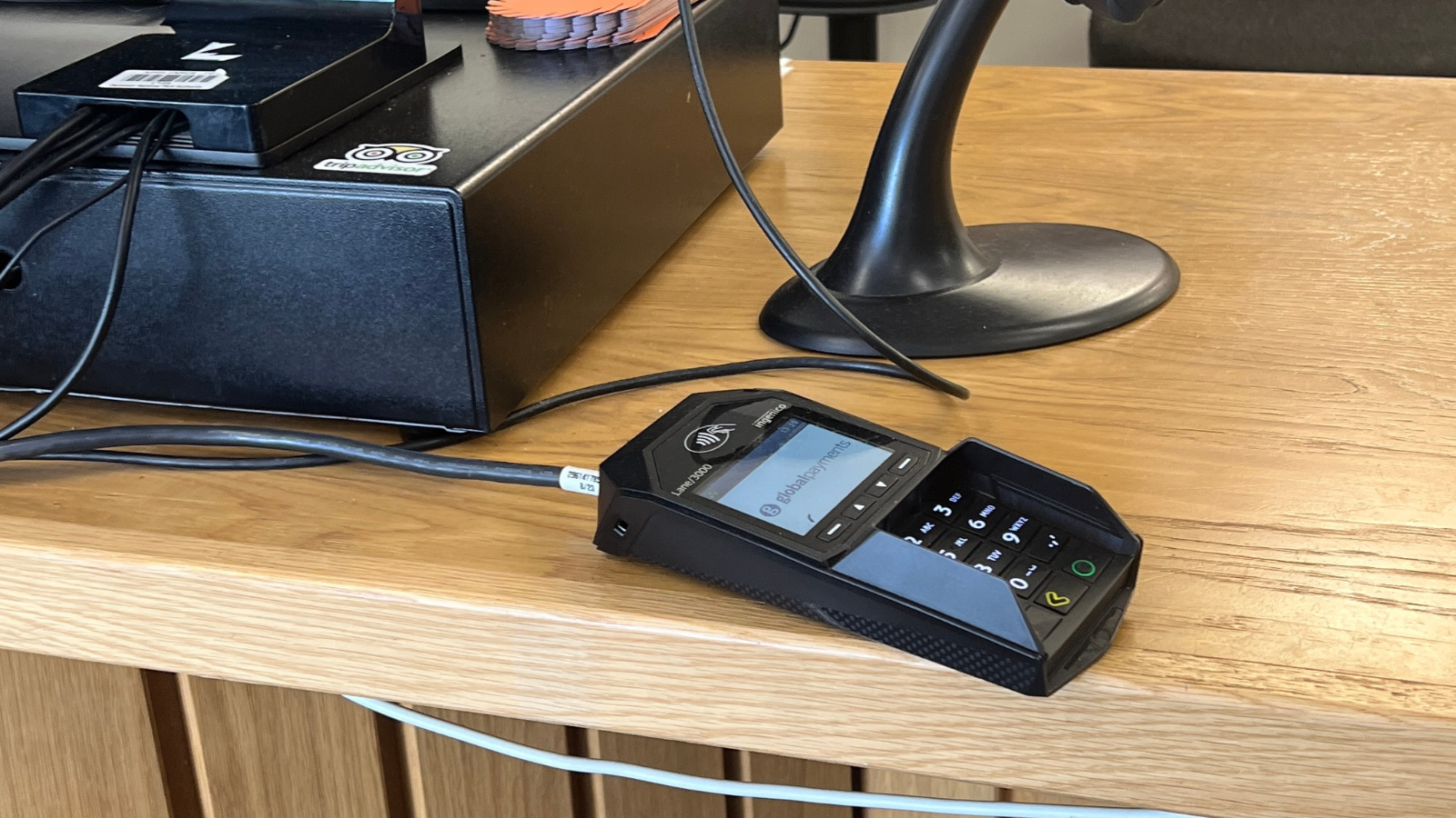 Close up of a black card machine resting on the counter