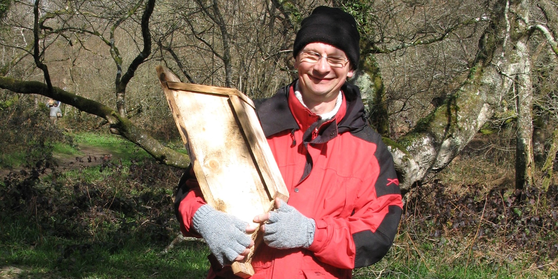 Volunteer helping put up bat box