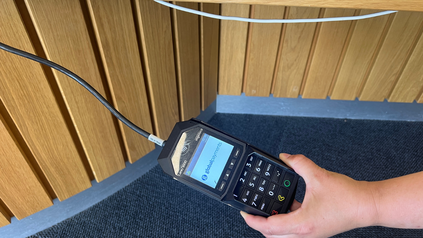 Close up of black card machine being held at a lower level