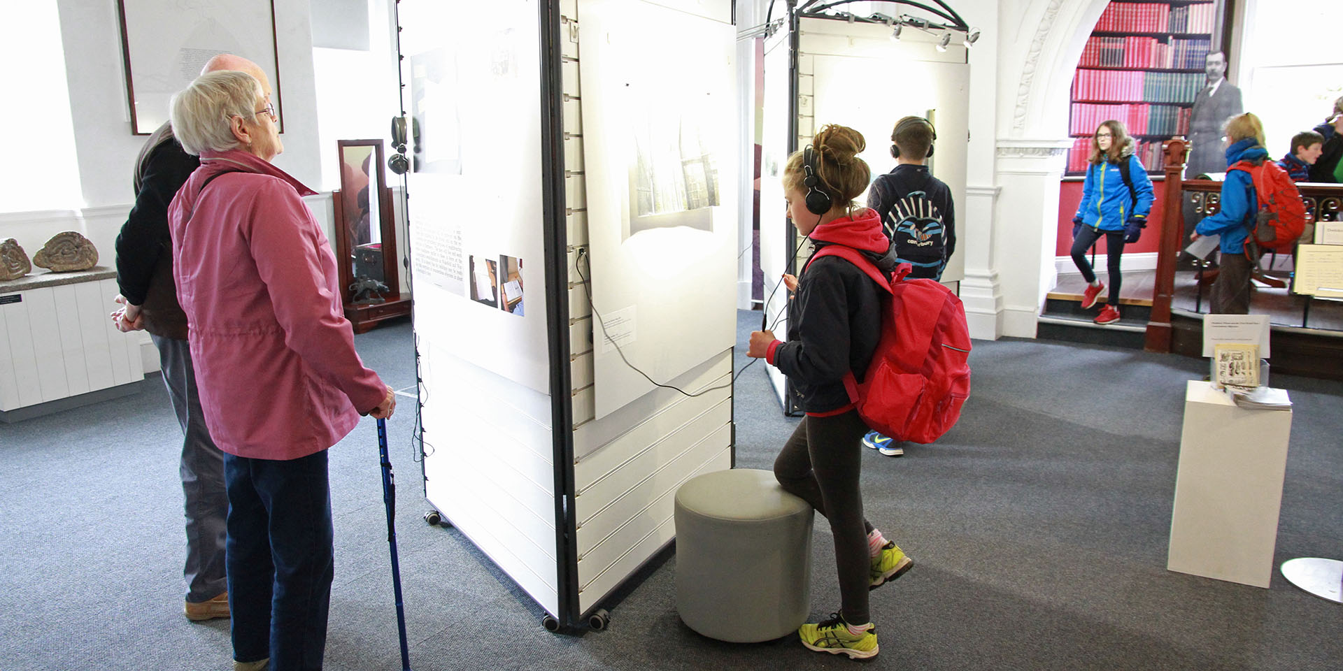 Older couple and school pupil enjoy the Conchies exhibit