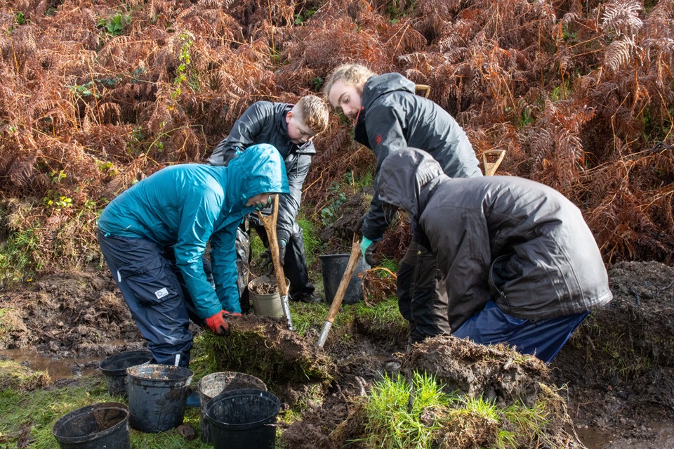 Youth Rangers with spades doing conservation work