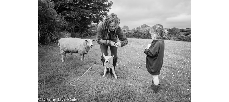 Mother and Daughter holding a lamb