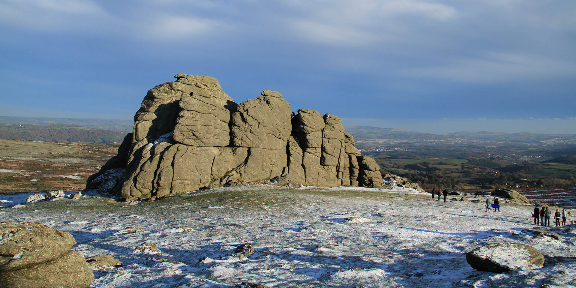 Visitors on Haytor rocks enjoying snow