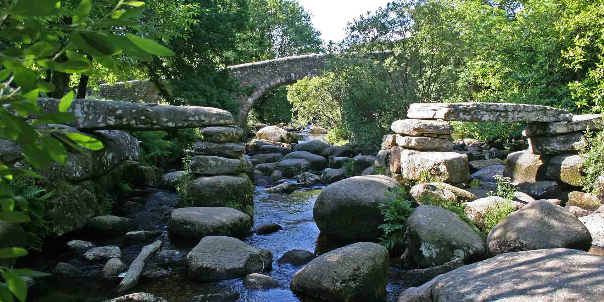 Dartmeet clapper bridge with modern bridge behind