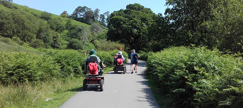 Disabled ramblers on trampers following a level path