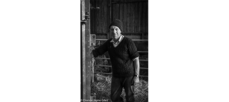 Farmer Kenny standing in a barn