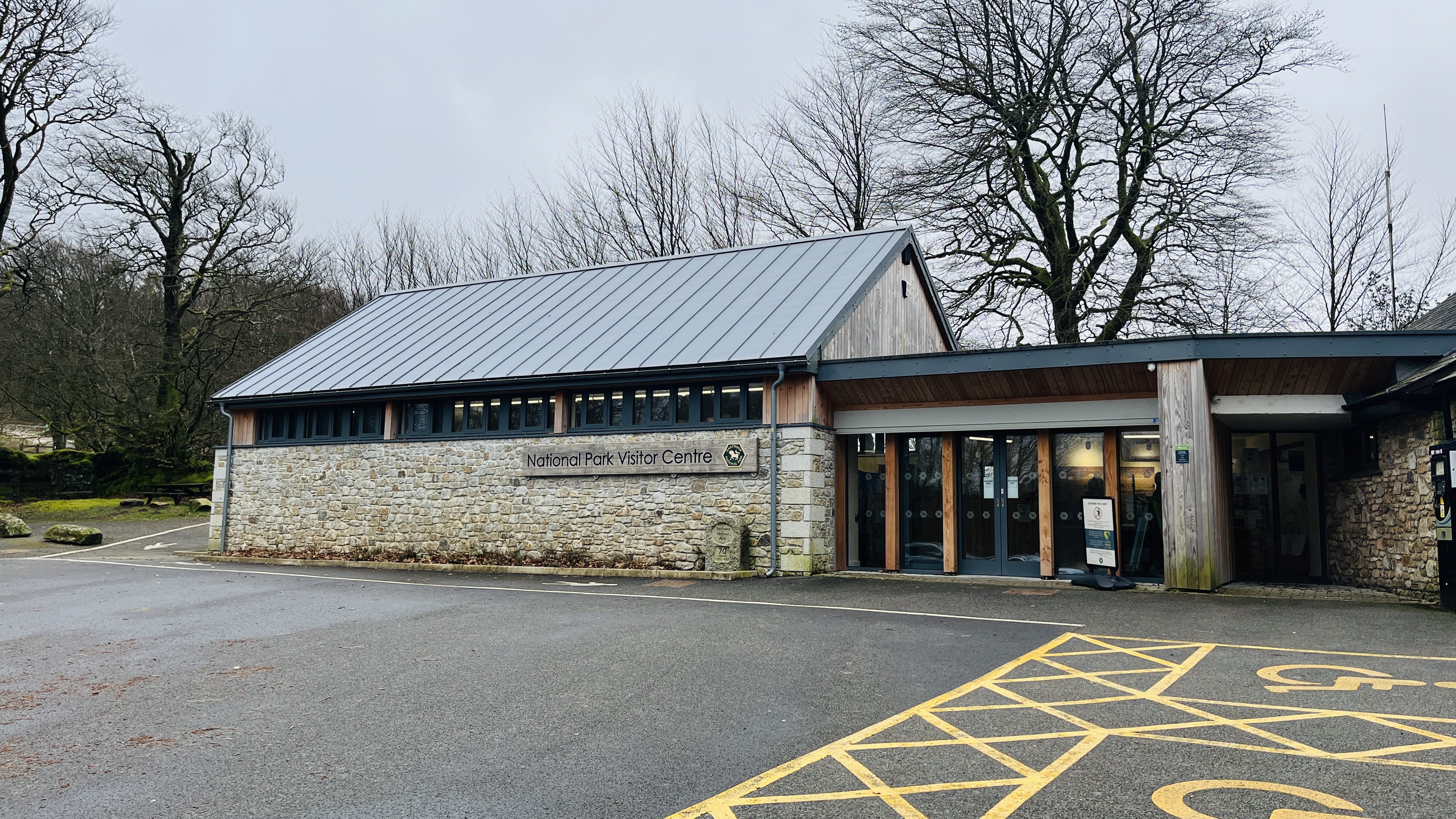Outside of Postbridge visitor centre showing large car park area in front of the building 