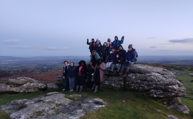 Group of people sat together at Haytor Quarry